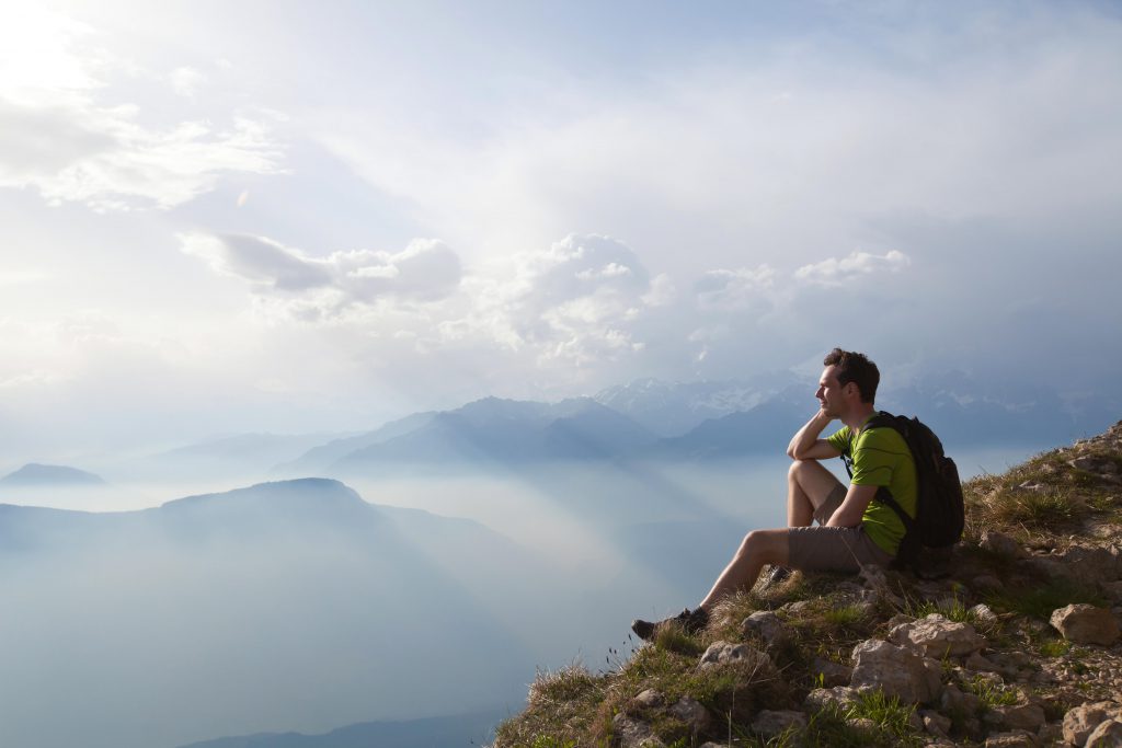 F588E8 traveler enjoying panoramic view during hike, beautiful background with mountain landscape